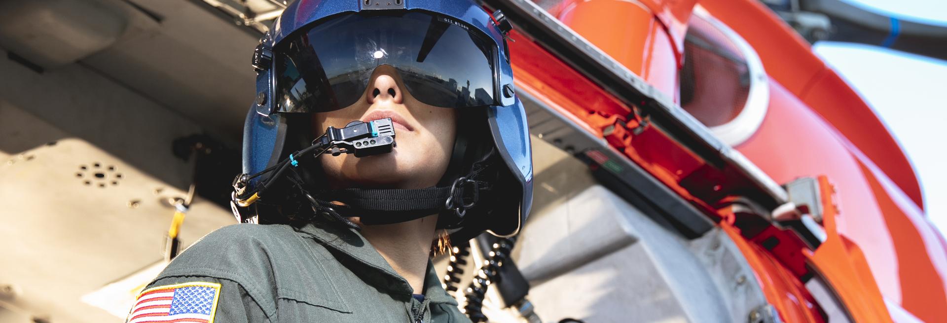 Female soldier in front of helicopter